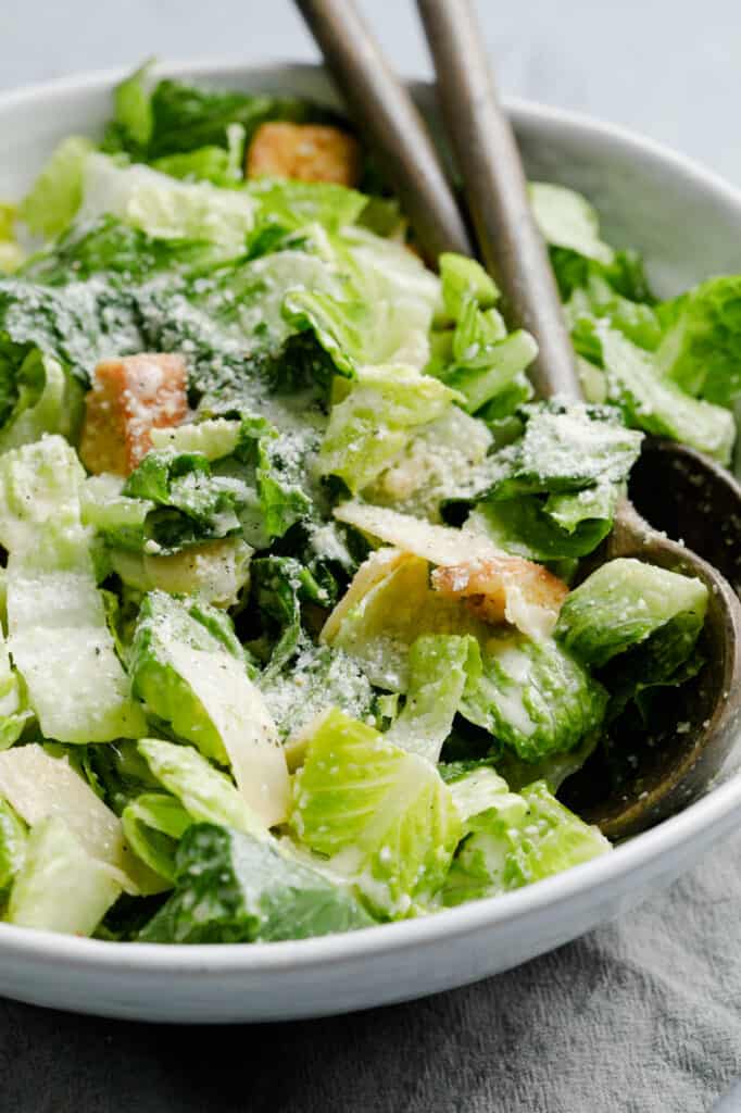 Closeup image of Caesar Salad recipe with croutons, parmesan cheese, romaine lettuce and garlic lemon dressing