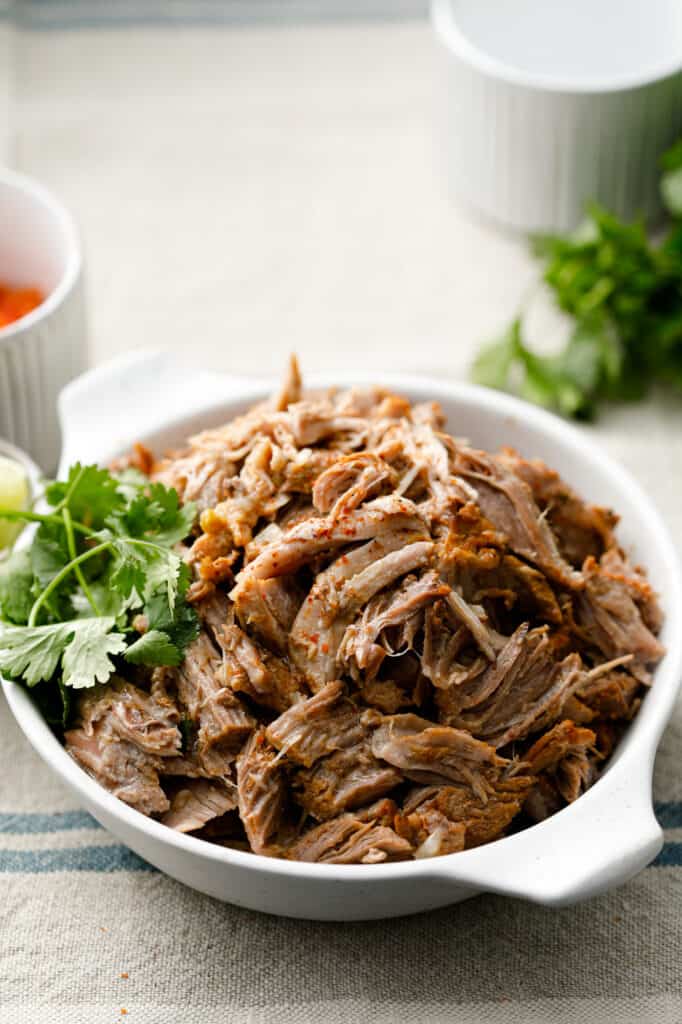 Pulled Pork Carnitas in a serving bowl with fresh cilantro