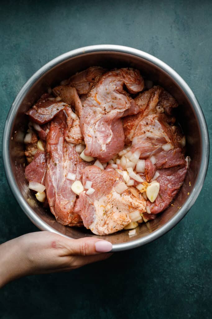 Overhead shot of pork carnitas ingredients prepared to be cooked in the instant pot