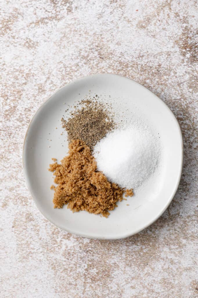 overhead image of a dish with brown sugar, salt and pepper