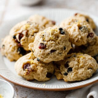 A plate of leftover oatmeal cookies with dried fruit pieces
