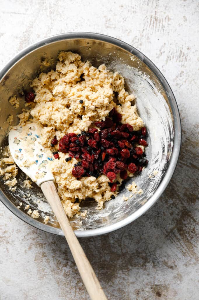 overhead view of mixing the oatmeal batter with the dried fruits