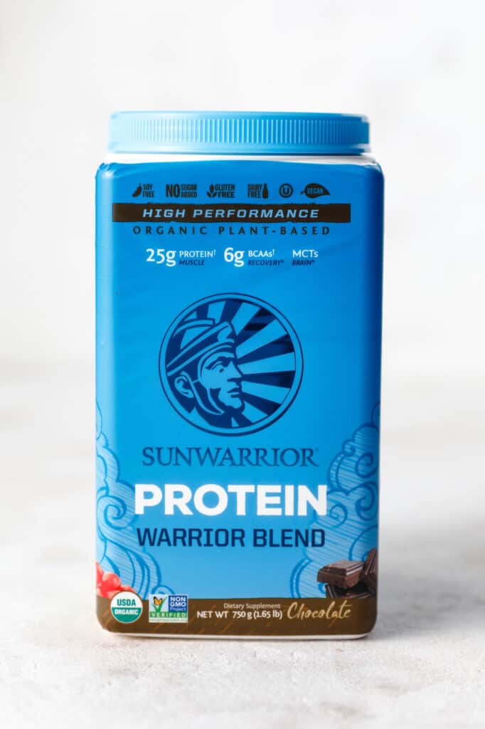 A container of sun warrior protein powder in chocolate flavor