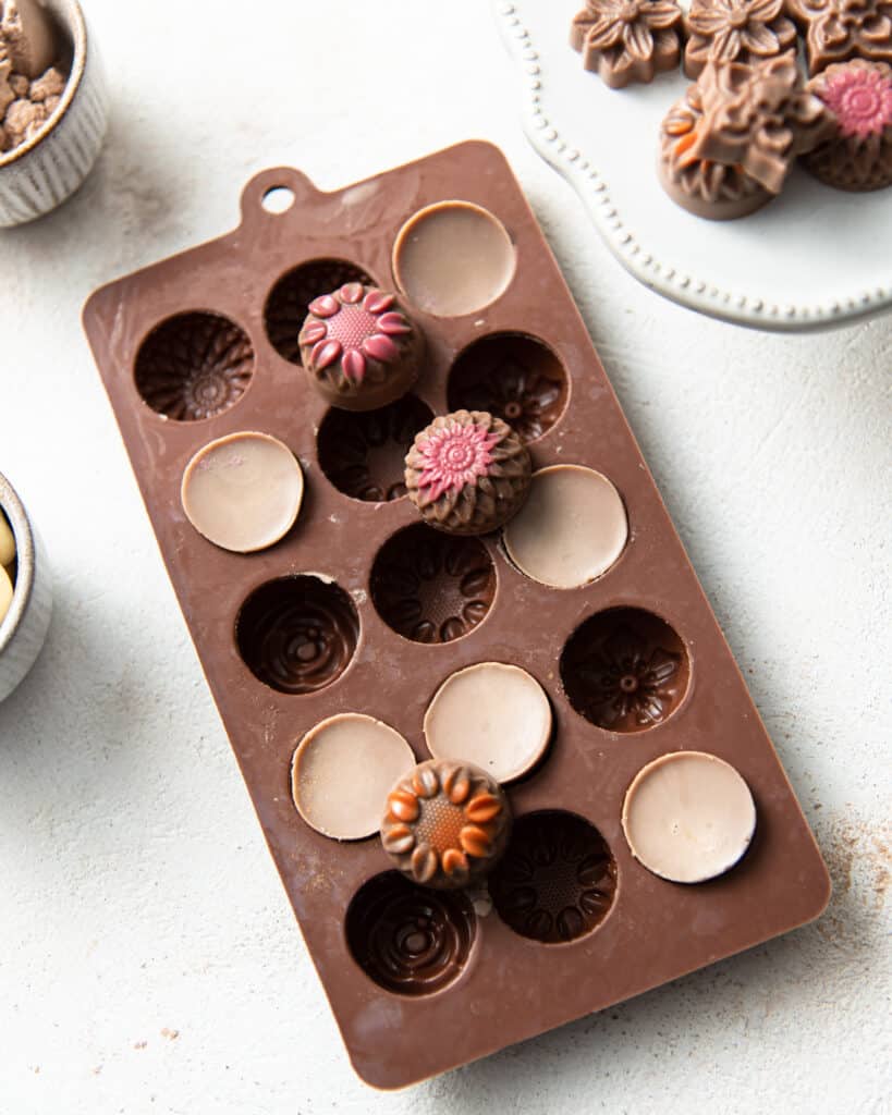 overhead view of a tray of chocolates in a mould with several removed