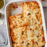 overhead view of a casserole dish of southwest chicken and rice casserole topped with cheese and black olives