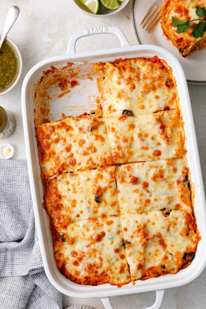 overhead view of a casserole dish of southwest chicken casserole topped with cheese and black olives