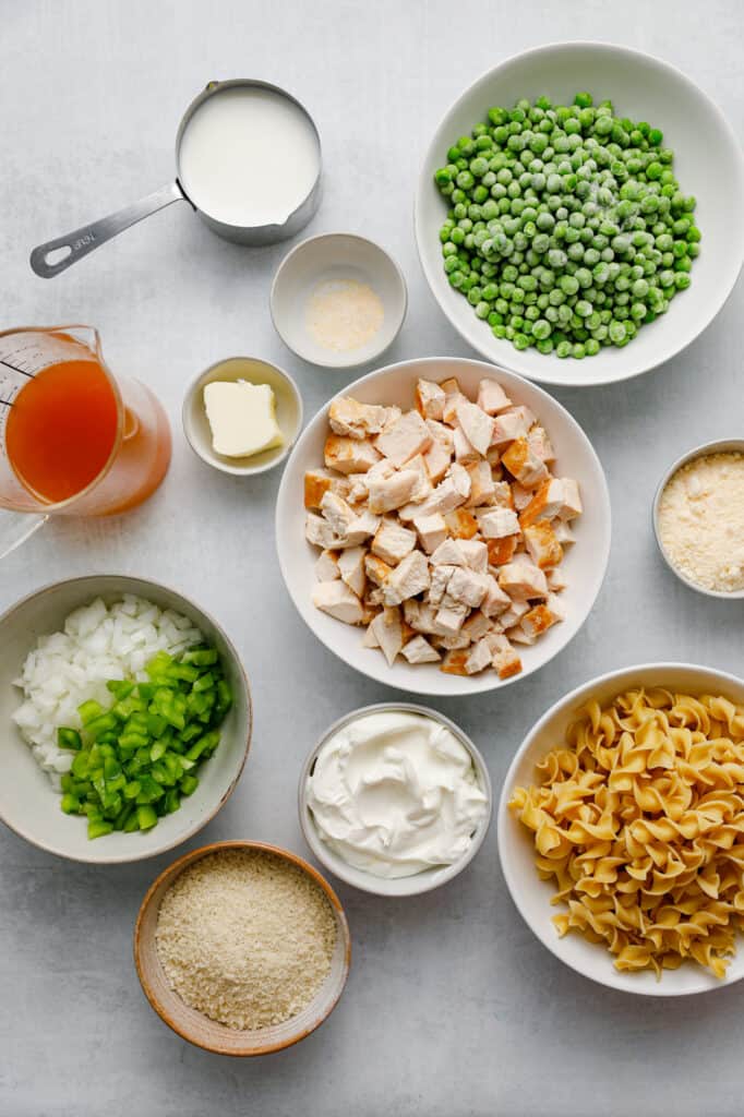 Ingredients for Creamy Chicken Noodle Casserole including frozen peas, egg noodles and sour cream