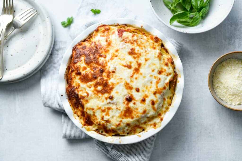 baked spaghetti pie straight from the oven with melty browned cheese on top