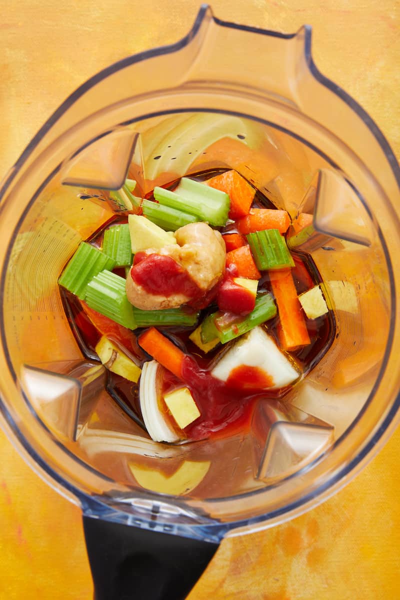 Overhead view inside a blender with the ingredients for salad dressing