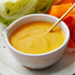 ginger salad dressing in a small bowl with a spoon