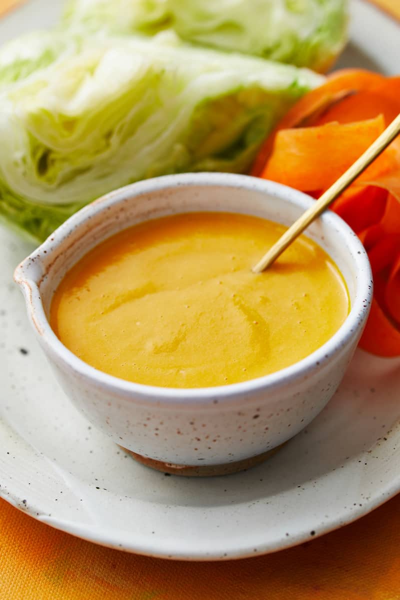 ginger salad dressing in a small bowl with a spoon