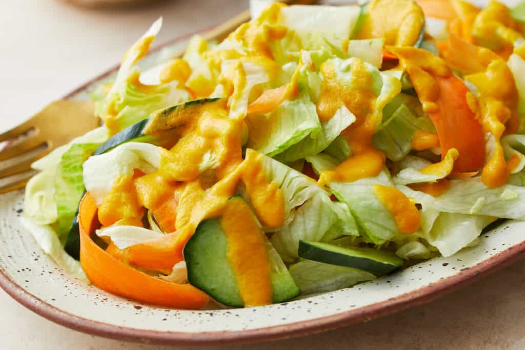 plated salad with iceberg lettuce and ginger salad dressing