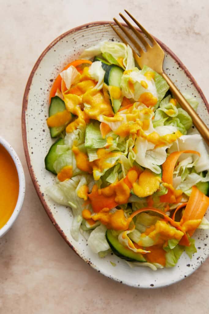 plated salad with iceberg lettuce and ginger salad dressing