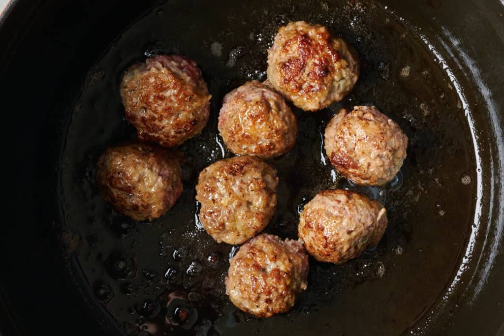 Meatballs in frying old being browned