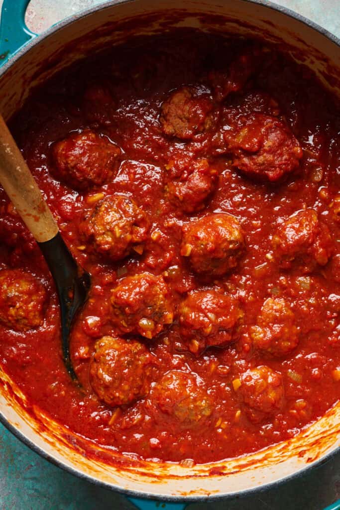 overhead view of meatballs in sauce in a large pot