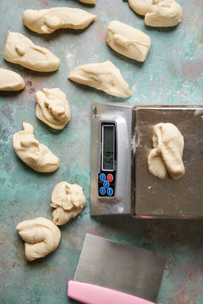 overhead view of a kitchen scale with 12 dough portions