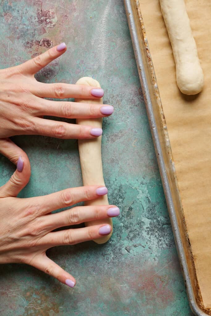 rolling the dough into a breadstick