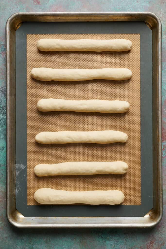 six breadsticks on a sheet pan