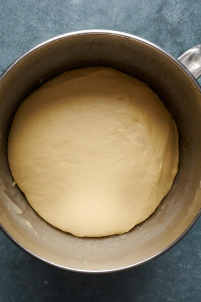 overhead view of dough in a bowl after it's doubled in size