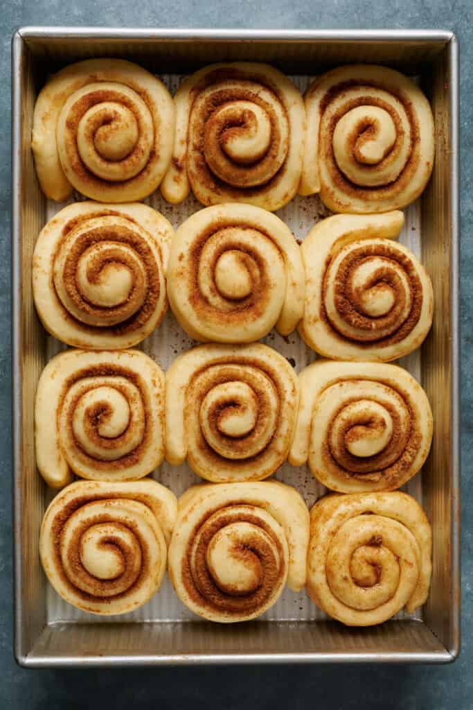 cinnamon rolls after they've risen and are ready to be baked