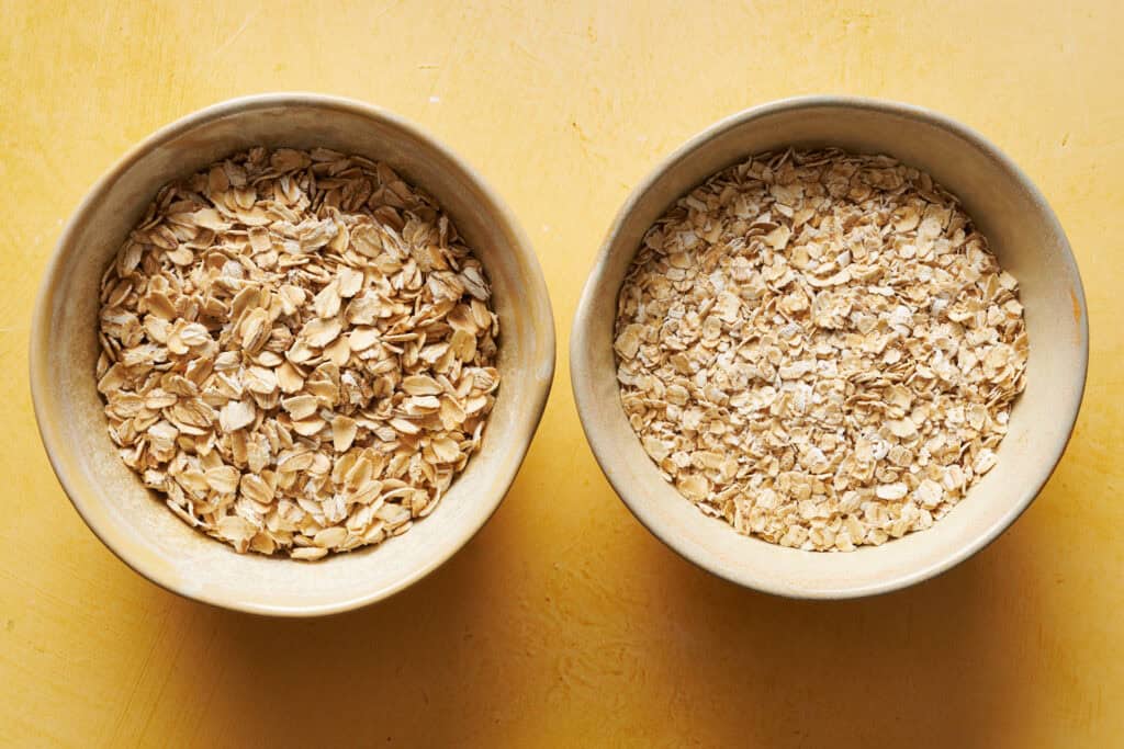 Image of dry oats. Quick cooking oats are pictured on the right and old fashioned  oats on the left.