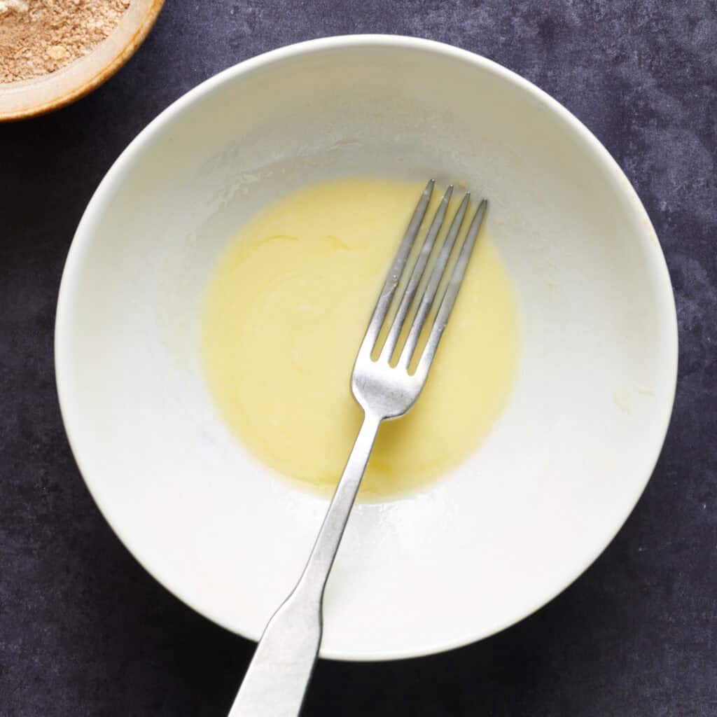 melted butter with a fork in a bowl