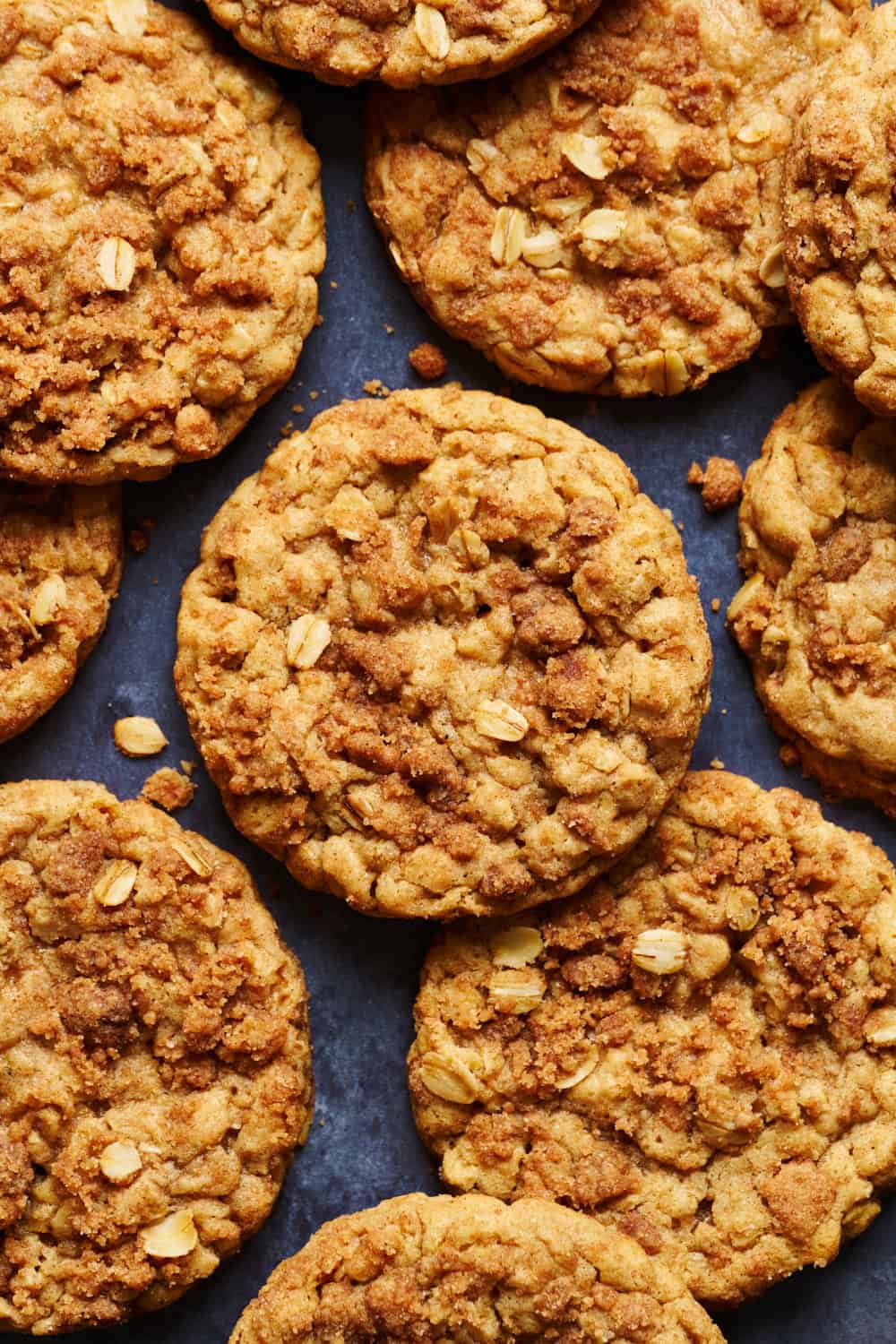 cinnamon oatmeal streusel cookies on a surface with scattered oats