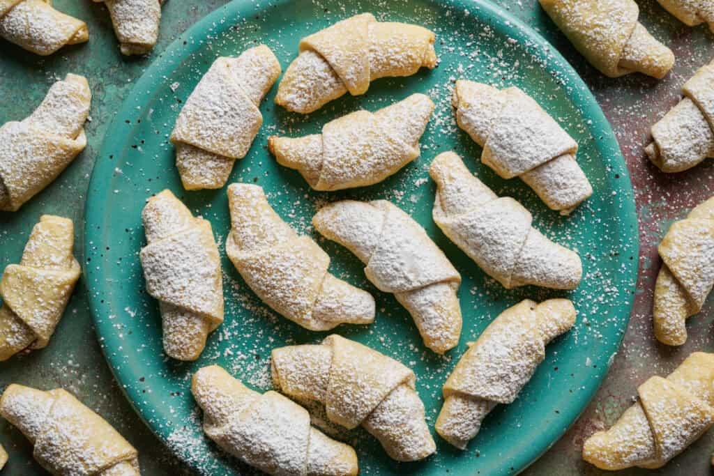 overhead view of kifle cookies on a turquoise plate