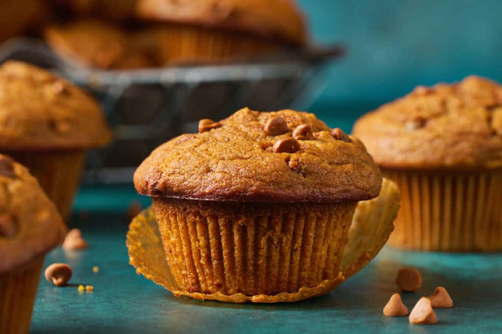 Closeup of a sourdough discard pumpkin muffin with the muffin liner removed