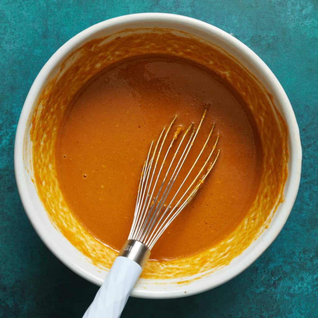 mixture of pumpkin, eggs, and sugars together in a bowl