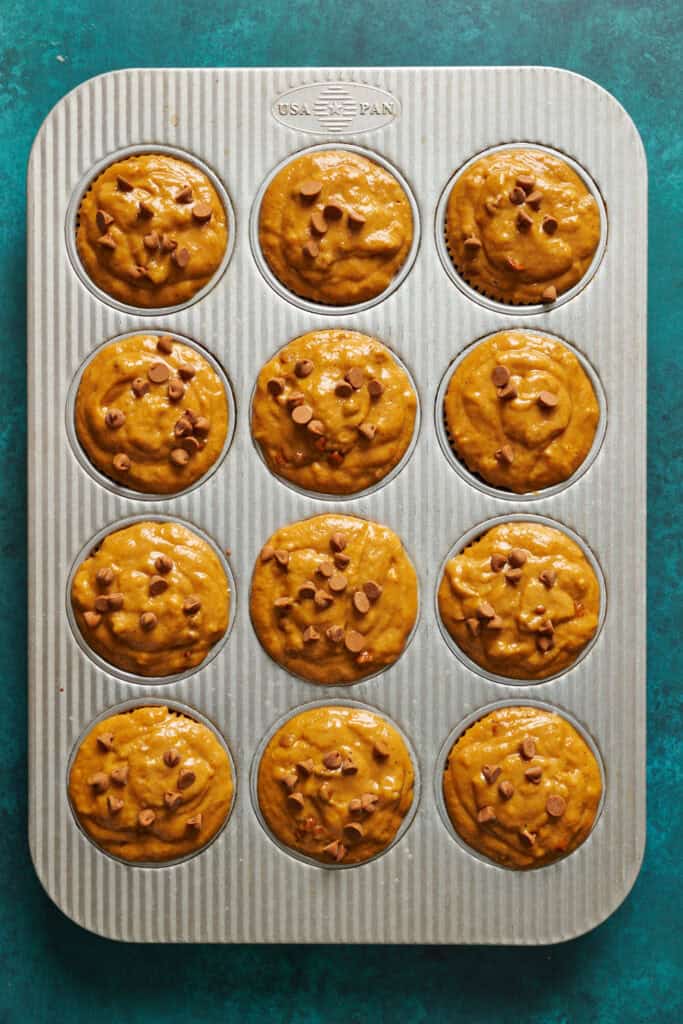 unbaked muffins in a muffin pan ready to be baked