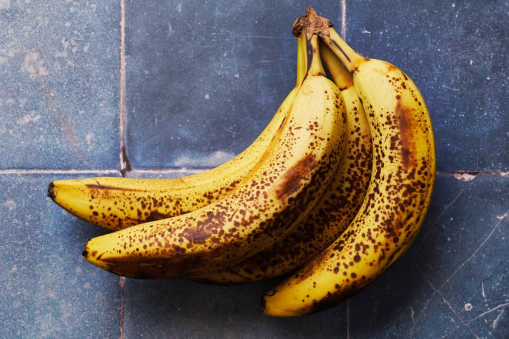 bananas on a blue tile background