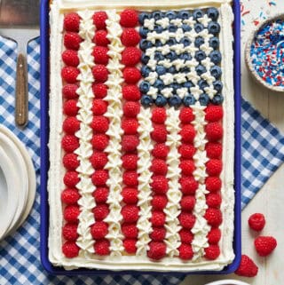 overhead view of a sheet cake decorated with fruit to look like the American flag