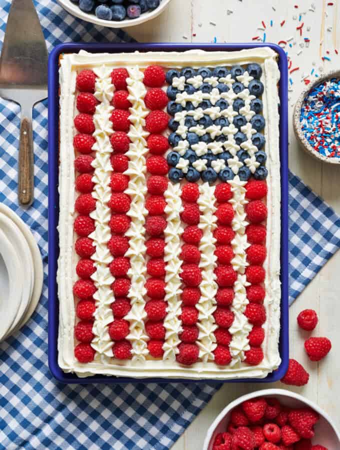 overhead view of a sheet cake decorated with fruit to look like the American flag