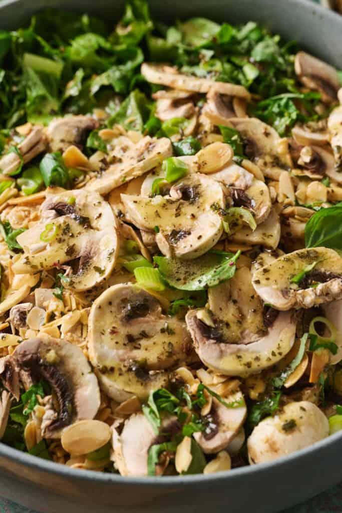 closeup of mushrooms and greens with dressing