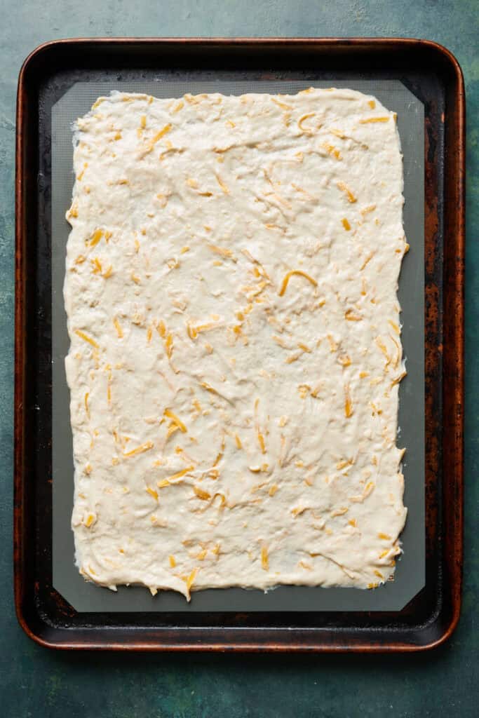 crackers batter spread thinly on a baking sheet