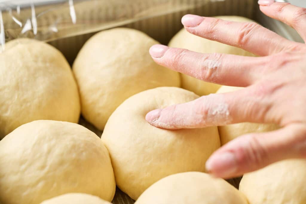 pressing finger into the proofed roll to test if it's ready