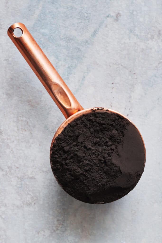 Black cocoa powder in a measuring cup