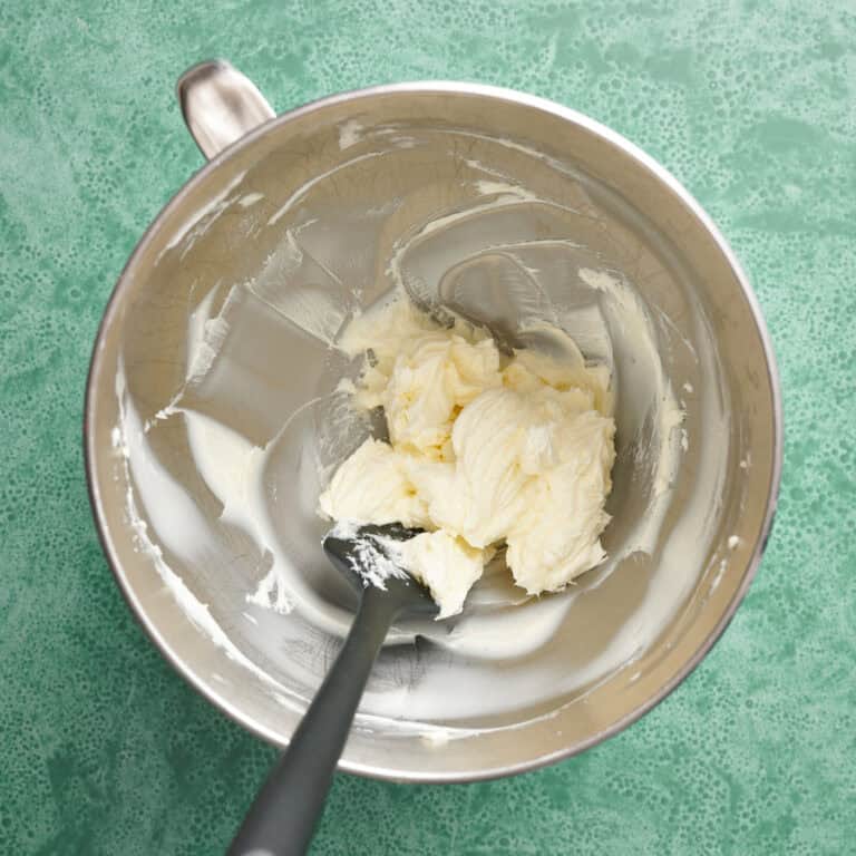 whipped butter in a metal bowl with a spatula