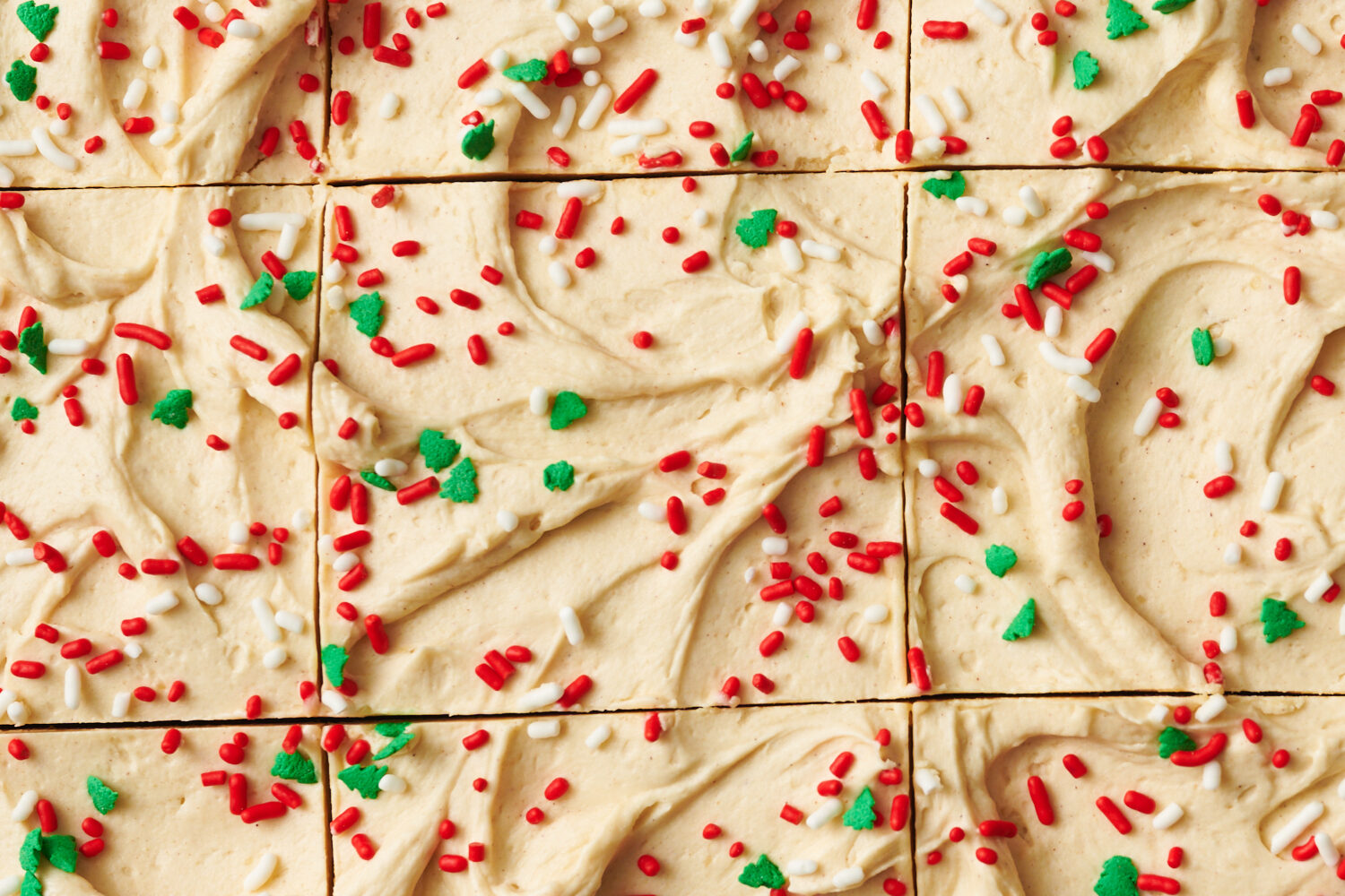 closeup of cinnamon molasses frosting with sprinkles on top and sliced into squares