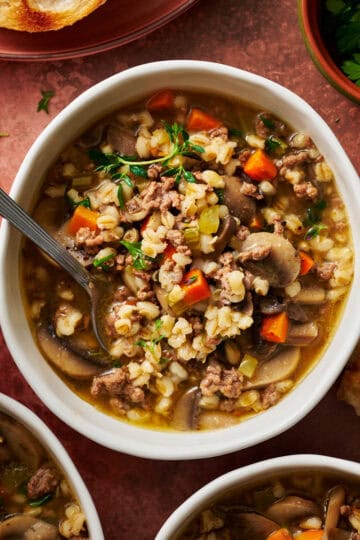 overhead view of a bowl of instant pot ground beef barley soup ready to eat