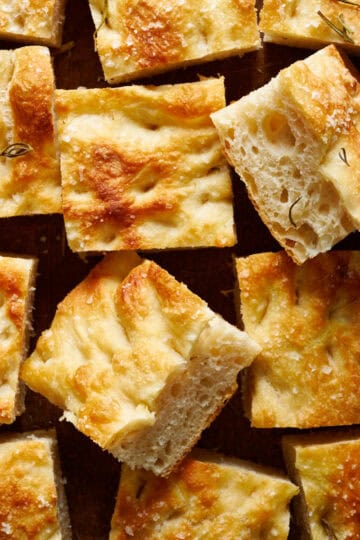 overhead view of slices of sourdough focaccia on a cutting board