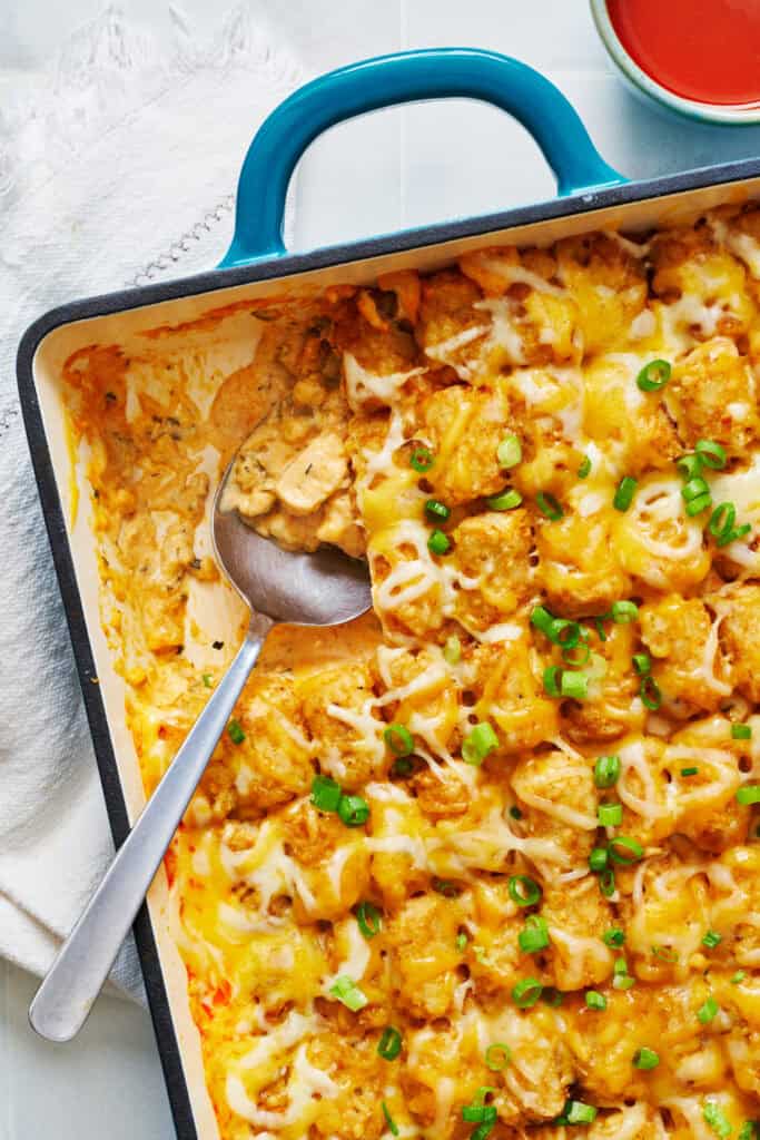 Overhead of a casserole dish wish a scoop of tatertot casserole taken out