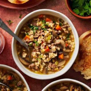 overhead view of a bowl of instant pot ground beef barley soup ready to eat