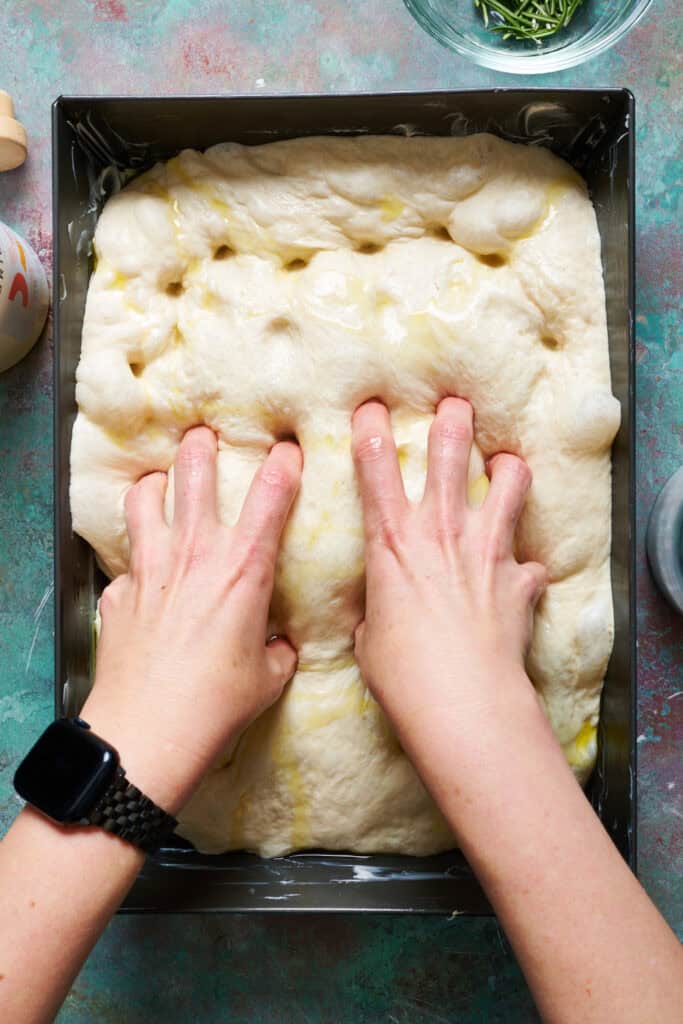 dimpling focaccia bread