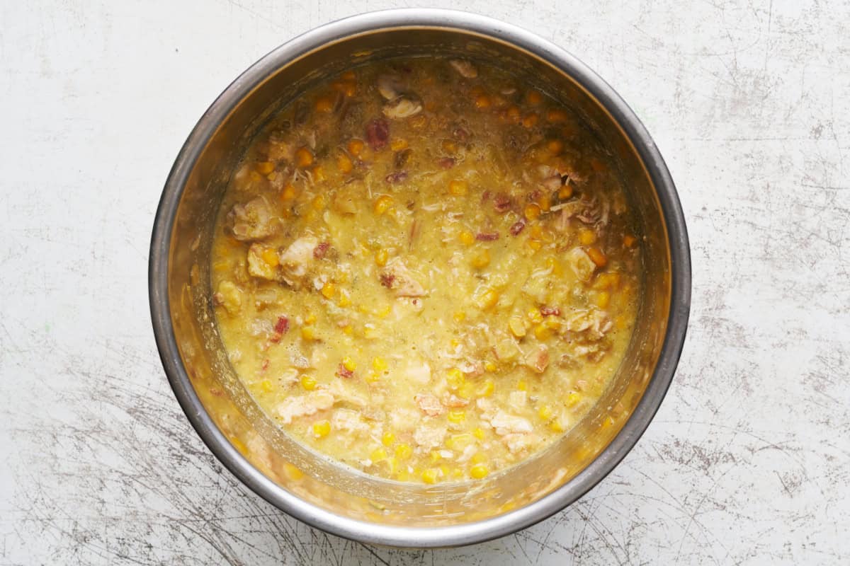 Overhead of an Instant Pot bowl with chicken corn chowder after its been cooked