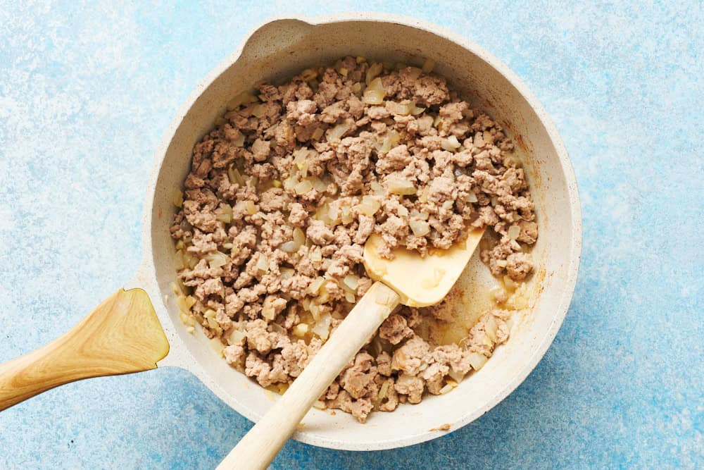 browned ground chicken and onions in a skillet