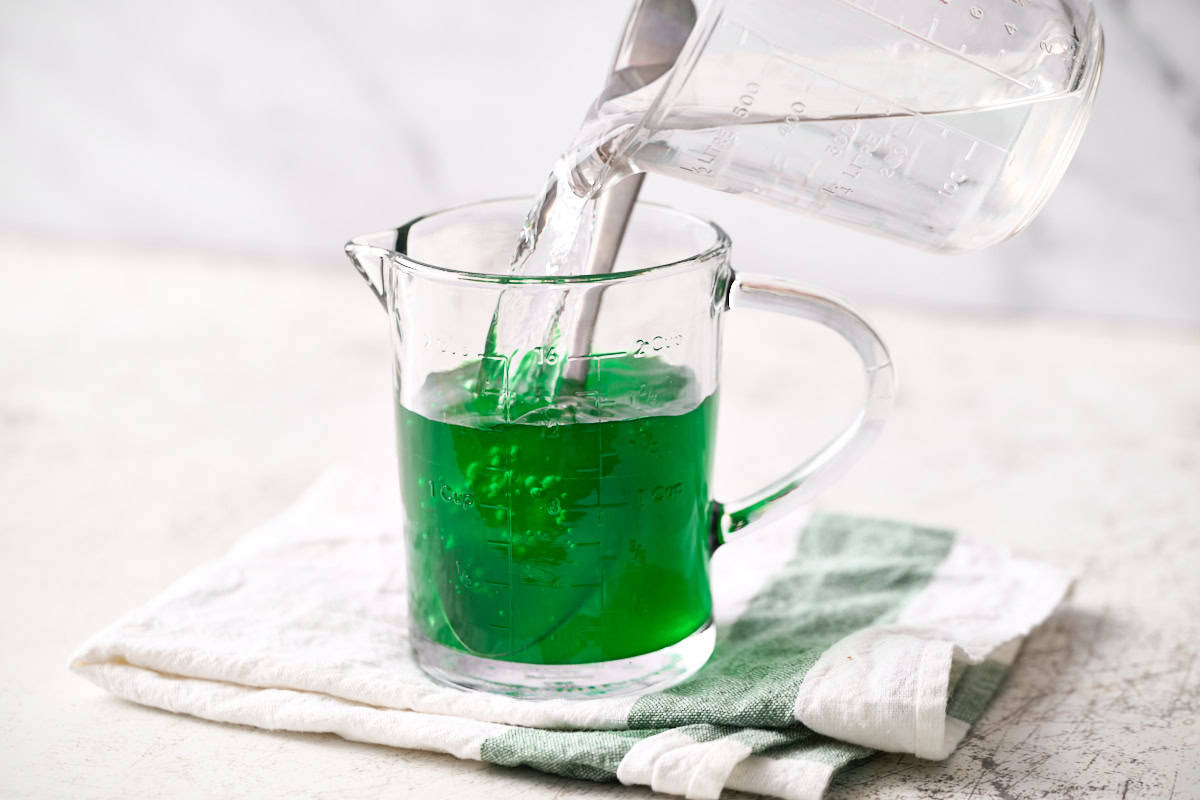 adding cold water to the dissolved jello