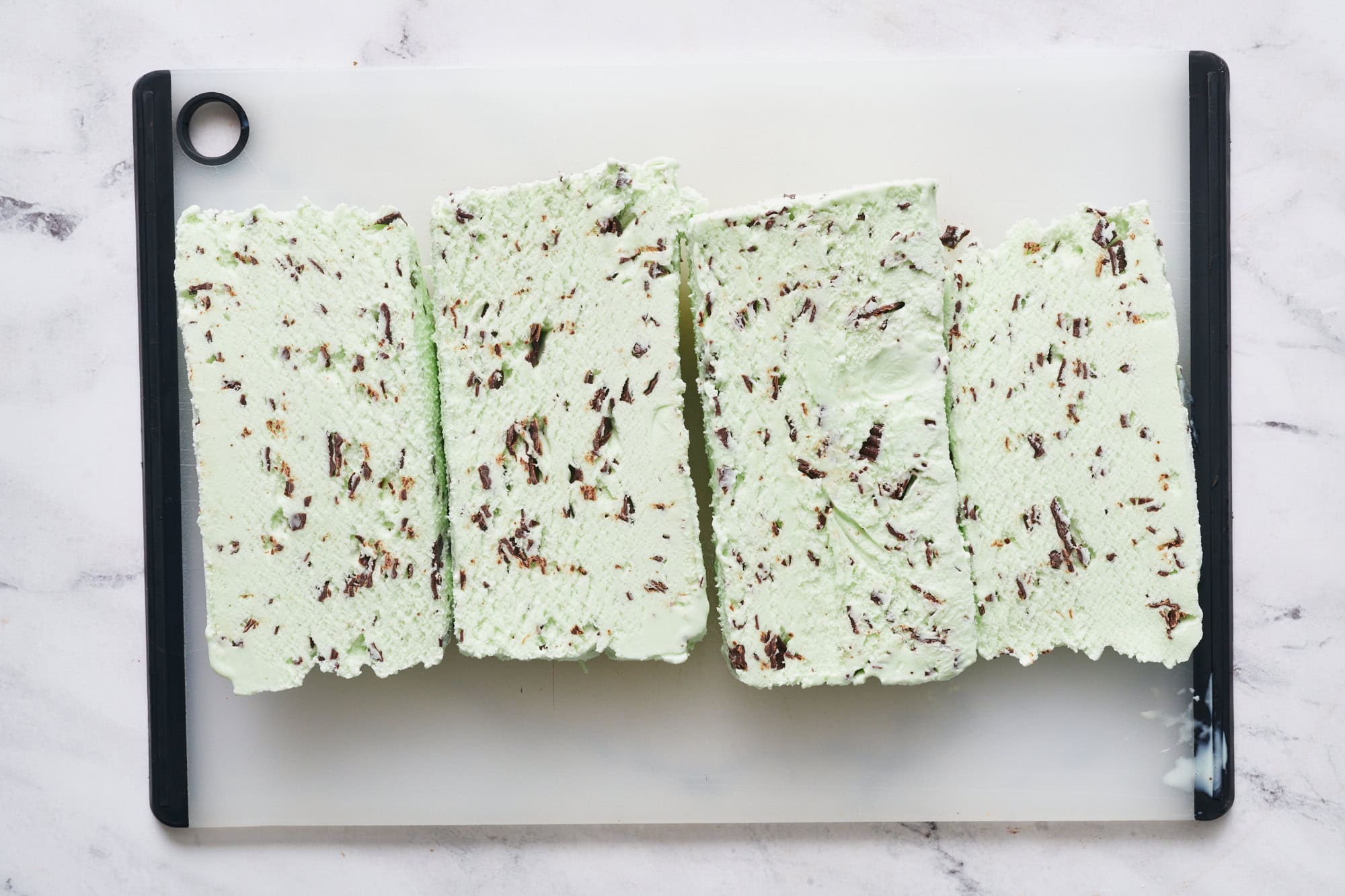 slices of mint chocolate chip ice cream from a half gallon container to make it easier to spread on the cake