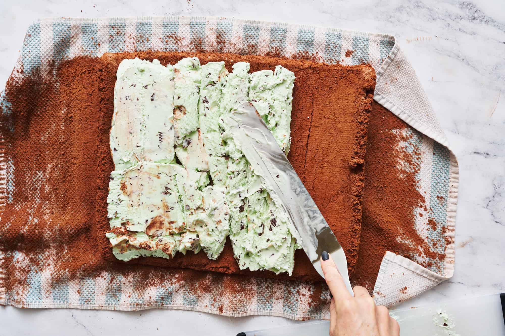 spreading ice cream on the chocolate angel food cake